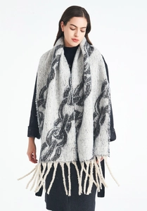 Detailed view of the thick mohair-style chain jacquard knit shawl with fringe