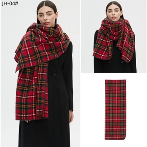 Detailed views of a red plaid tartan shawl scarf styled with a black coat and flat layout