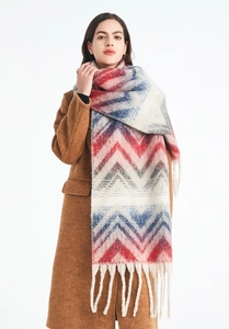 Close-up of red, blue, and white wave pattern knit scarf with long decorative fringe