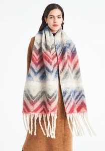 Detail of multi-color chevron knit scarf with long fringes worn on a brown wool coat
