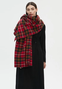 Detailed view of the woven texture and classic red plaid pattern on this winter shawl