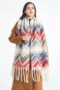Macro detail of mountain jacquard knit scarf with thick tassels and fuzzy texture