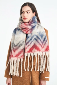Close-up of thick chevron knit scarf with vibrant red and blue waves and long tassels