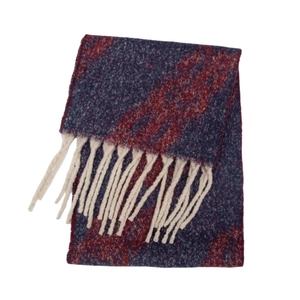 Detail of jacquard chain pattern and long cream tassels on navy knit winter shawl