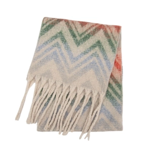 Detail of colorful zigzag knit pattern scarf with thick beige decorative tassels