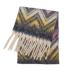 Detail of wavy jacquard pattern and chunky tassels on soft chunky yarn scarf