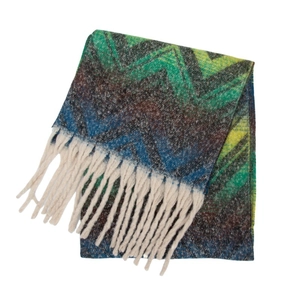 Detailed knit texture of wavy pattern scarf with white tassel fringe accents