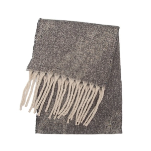 Close-up of thick greige boucle knit scarf featuring decorative beige tassel fringe details