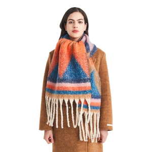 Thick colorful striped knit scarf with long fringes worn on a classic brown coat