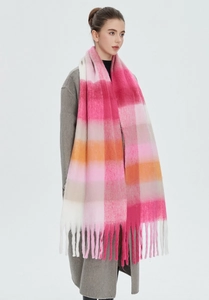 Detail of soft mohair texture and colorful plaid patterns with long tassel finish