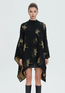Detail of black knit shawl featuring golden ginkgo leaf jacquard patterns and split hem