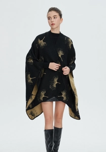 Detail of black knit shawl with gold ginkgo leaf jacquard and double-sided design
