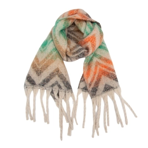Close-up of vibrant mountain pattern knit scarf with long decorative tassels and texture