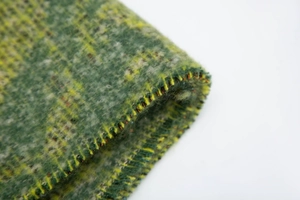 Detail of green and yellow plaid mohair-style shawl fabric with thick fuzzy texture