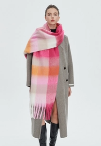 Detailed view of colorful pastel rainbow plaid scarf with long fringes for winter style