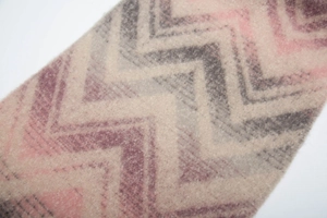Macro shot of thick mountain wave jacquard knit fabric with soft fringe texture