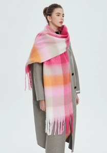 Detail of colorful rainbow plaid scarf with thick mohair texture and soft tassels