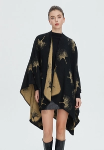 Close-up of black and gold ginkgo leaf pattern on elegant knitted split shawl wrap