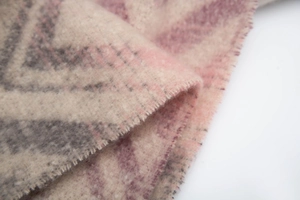 Close-up of soft mountain pattern scarf with bouclé yarn texture and fringed edges
