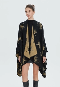Detail of premium black shawl featuring golden ginkgo leaf patterns and fine knit edges