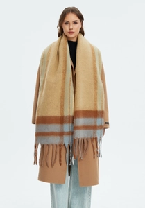 Detailed close-up of thick multi-color plaid scarf with long fringe and fuzzy texture