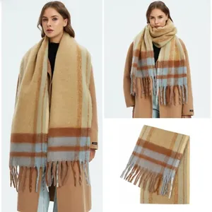 Detail of soft khaki plaid mohair scarf with tassels and close-up of thick knit texture