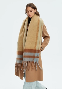 Detailed texture of thick checkered shawl with soft fringe and brown-blue plaid pattern