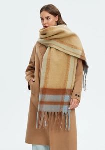 Macro view of the thick mohair-like khaki plaid scarf with long fringes and wool coat