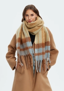 Close-up of thick plaid mohair-style scarf with fringe on a camel wool coat