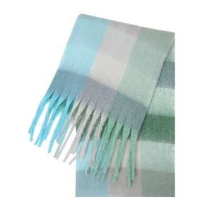 Macro detail of thick winter plaid scarf with soft mohair texture and fringe tassels