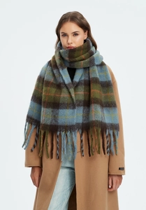 Close-up of thick plaid scarf texture with fringes in blue, green and orange colors