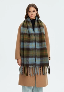 Detailed texture of thick khaki plaid scarf with long fringe and vintage British pattern