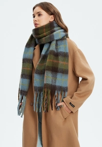 Close-up of thick checkered scarf with long twisted tassels and soft brushed texture
