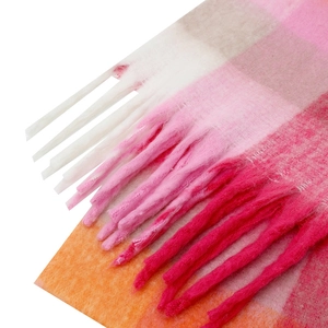 Detailed view of colorful mohair scarf texture featuring pink plaid pattern and long tassels