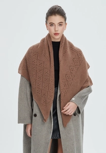 Detail of a brown knit hollow-out triangular shawl with geometric crochet pattern