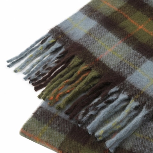 Close-up of thick plaid mohair scarf texture with green and brown tassels