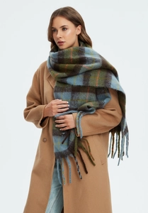 Detail of the thick checkered mohair scarf with long tassels and soft fuzzy texture