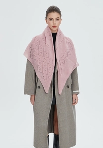 Detail of pink knitted openwork shawl with diamond pattern over a grey wool coat