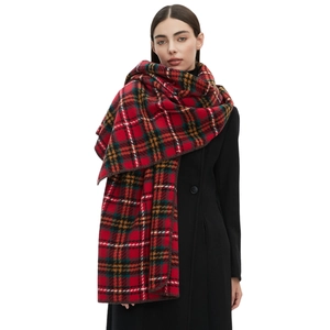 Red plaid scarf with classic tartan pattern and lockstitch edges on a model in studio