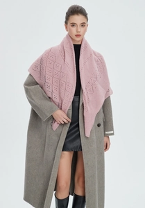 Detailed view of pink knitted hollow-out shawl with elegant diamond patterns