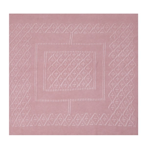Close-up of pink knitted shawl featuring white geometric diamond patterns and fine texture