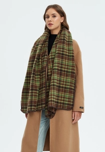 Thick green plaid scarf worn over a beige coat showing premium texture and drape