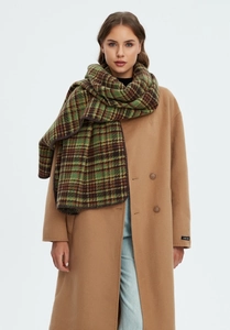 Detailed texture of thick green plaid Christmas scarf paired with a camel wool coat