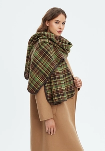 Close-up of thick green plaid scarf showing premium wool texture and neat edge stitching