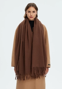 Close-up of deep brown soft shawl with long tassels showing premium wool-like texture