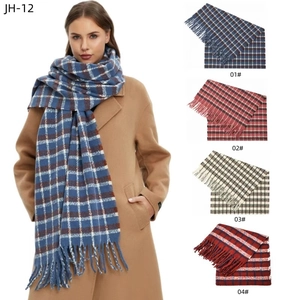 Detailed view of the soft fringe edges and classic blue plaid pattern on winter scarf