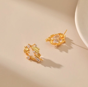 Gold irregular geometric stud earrings featuring inlaid transparent rectangular crystals