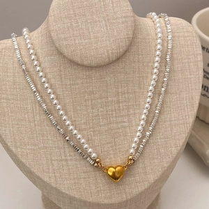 French vintage double-layered pearl and silver bead necklace with a gold magnetic heart pendant