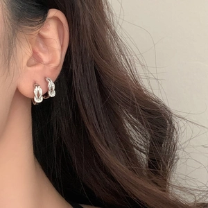 Elegant silver knot earrings with pavé zircon stones on model for a minimalist look