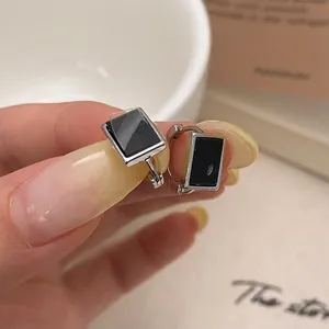 Minimalist rectangular silver earrings with black inlay and sleek metal finish